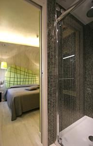 a bedroom with a bed and a glass shower at Hotel La Pergola in Grezzana