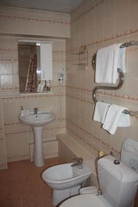 a bathroom with a toilet and a sink at Berkana Hotel in Almaty +30 photos