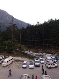a group of cars parked in a parking lot at Hotel Hema Holiday Home in Manāli