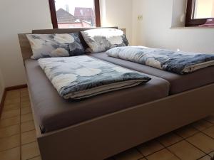a bed with two pillows on top of it at Ferienwohnung Ernesto in Rust +21 photos