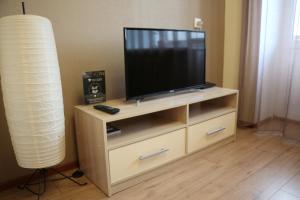 a flat screen tv on a wooden entertainment center at "GOOD NIGHT" on Pirogova 7 in Tomsk