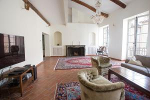a living room with a couch and chairs and a fireplace at Chateau Clemenceau in Antibes