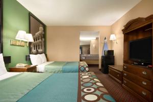 A bed or beds in a room at Super 8 by Wyndham Hattiesburg North