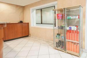 a room with a shower with a glass door at Super 8 by Wyndham Edmonton/West in Edmonton