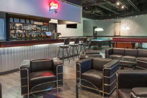 a bar with leather chairs and a pool table at Super 8 by Wyndham Edmonton/West in Edmonton