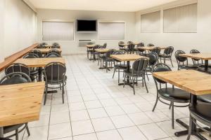 an empty classroom with tables and chairs at Super 8 by Wyndham Edmonton/West in Edmonton