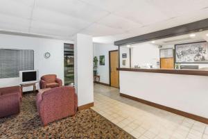 a waiting room with two chairs and a counter at Super 8 by Wyndham Pompano Beach in Pompano Beach