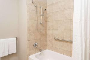 a bathroom with a shower with a bath tub at Super 8 by Wyndham Pompano Beach in Pompano Beach