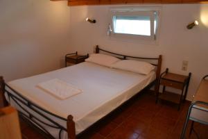 a bed in a room with a window and a bed sidx sidx sidx at Skiathos Studios Panorama in Skiathos