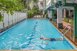 a man in a swimming pool at a hotel at New Siam II in Bangkok