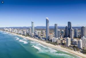 a view of a beach with tall buildings and the ocean at 2BD Family or Couple Guesthouse Upstairs near Turf club, HOTA in Bundall in Gold Coast