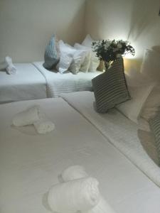 a hotel room with two beds with towels on them at Shalamanzi Lodge in Hartbeespoort
