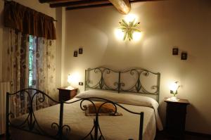 a bedroom with a bed with a wrought iron headboard at Agriturismo Il Sasso in Anghiari