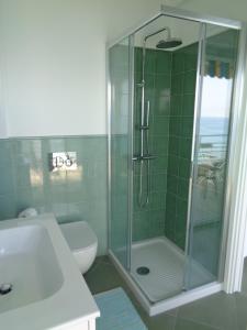 a bathroom with a shower and a toilet and a sink at Studio La Florentina in Menton