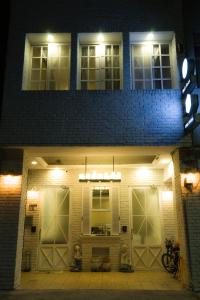 a house with two garage doors at night at Hualien Bird's House Hostel in Hualien City