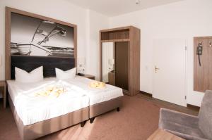 Ein Bett oder Betten in einem Zimmer der Unterkunft Villa Auszeit Hotel Garni
