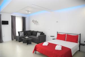 a bedroom with a large bed and a couch at City Heart Luxury Studios in Rhodes Town