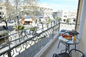a balcony with a table and a bowl of fruit at City Heart Luxury Studios in Rhodes Town