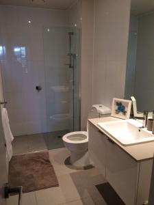 a bathroom with a toilet and a shower and a sink at Marina View Apartment on the Maribyrnong River, Melbourne in Maribyrnong +34 photos