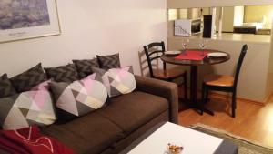 a living room with a couch and a table at Cosy studio apartment in Vaasa