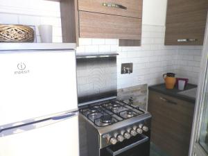 a kitchen with a stove top oven in a kitchen at Terrazza Bello in Portovenere