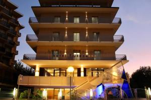 a building with a lit up facade at night at Hotel Tritone Rimini in Rimini