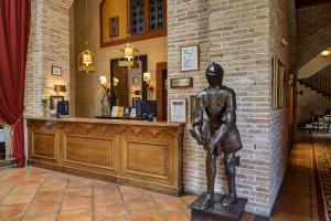 a statue of a man standing in front of a bar at Parador de Olite in Olite
