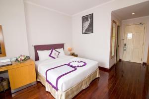 Postel nebo postele na pokoji v ubytování TTC Hotel - Ngoc Lan