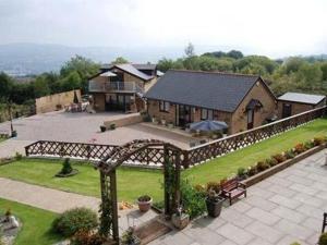 an aerial view of a house with a yard at Winchfawr Lodge in Merthyr Tydfil