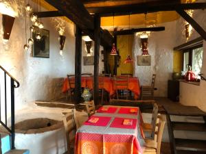 a dining room with a table and a table and chairs at La Fructuosa in Gaucín +64 photos