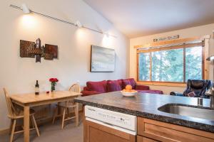 a kitchen and living room with a couch and a table at Northstar - Ski Trail Condo in Kingswood Estates
