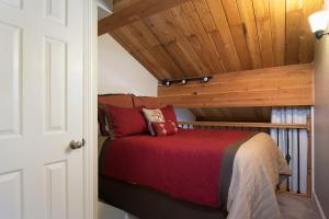a bed in a room with a wooden ceiling at Northstar - Village View in Kingswood Estates