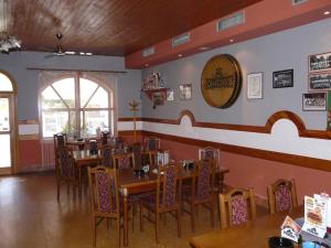 a dining room with tables and chairs in a restaurant at Penzion u Formana in Stráž nad Nežárkou