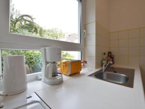 a kitchen counter with a sink and a window at Ferienhaus Ostseeblick in Kühlungsborn in Kühlungsborn +32 photos