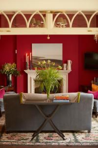 a living room with a couch and a table at The White House in Burnham Market