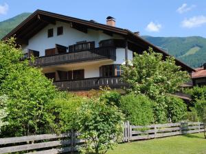 a house with balconies on the side of it at Premium-Chalet Achental mit Kamin und Sauna in Schleching