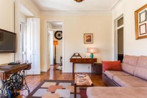 a living room with a couch and a table at ALTIDO Fernando Pessoa Apartments in Lisbon