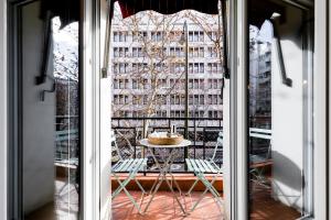 a view of a window with a table and a building at Principe de Vergara Apartment II by Flatsweethome in Madrid