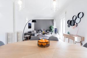 a living room with a dining room table and a living room with a couch at Principe de Vergara Apartment II by Flatsweethome in Madrid