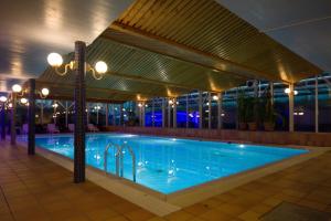 a large swimming pool in a building at night at Bohusgården Hotell & Konferens in Uddevalla