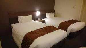 Postel nebo postele na pokoji v ubytování Hotel Ascent Plaza Hamamatsu