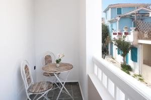 a small table and two chairs on a balcony at The Secret Boutique Hotel in Lefkada Town