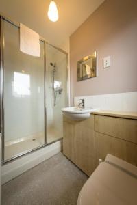 a bathroom with a shower and a sink and a toilet at Taigh Mhuirne in Portree