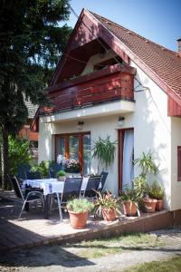 a house with a table and chairs on a patio at Apartment House 41 in Sopron