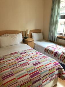 A bed or beds in a room at Seven Dials Hotel 