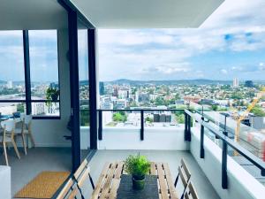 a balcony with benches and a view of a city at AirTrip Apartments on Merivale Street in Brisbane