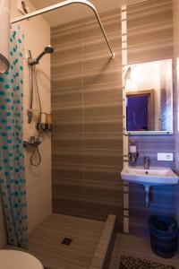 a bathroom with a shower and a sink at Solo Apartment Dragomanova in Kyiv