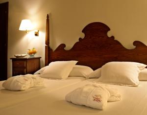 a bedroom with two towels on a bed at Hotel Cala Sant Vicenç - Adults Only in Cala de Sant Vicenc