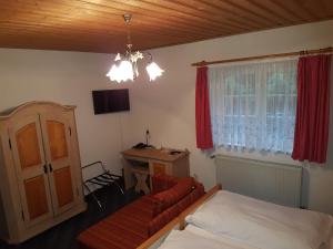 a bedroom with a bed and a couch and a desk at Land-gut-Hotel Zur Lochmühle in Penig