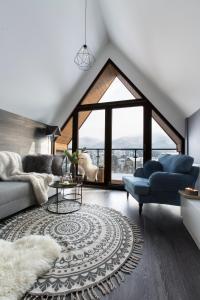 a living room with a couch and a table at Polana Szymoszkowa Ski Resort in Zakopane